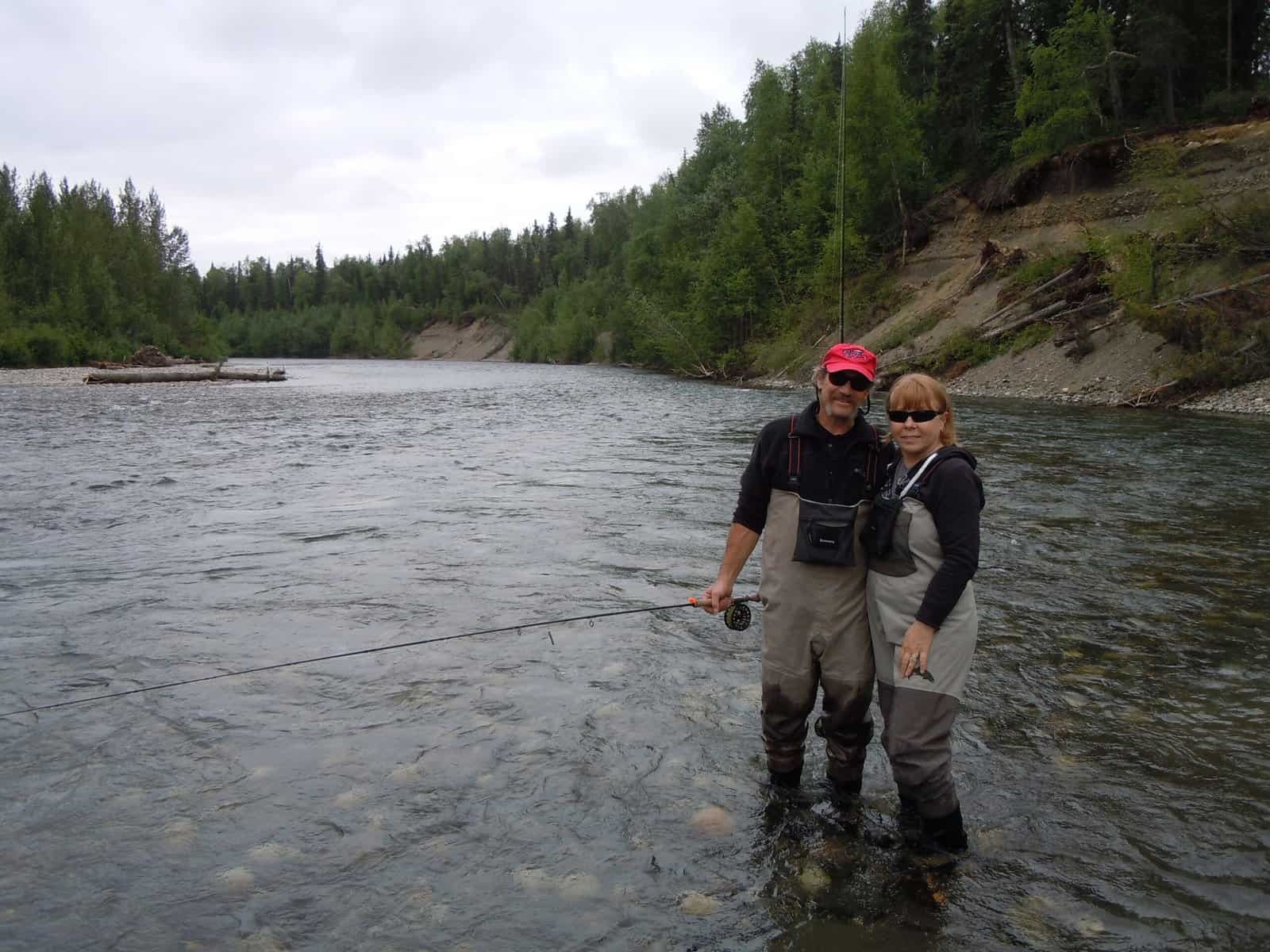 A couple on a private fishing trip in Alaska at Wilderness Place Lodge.