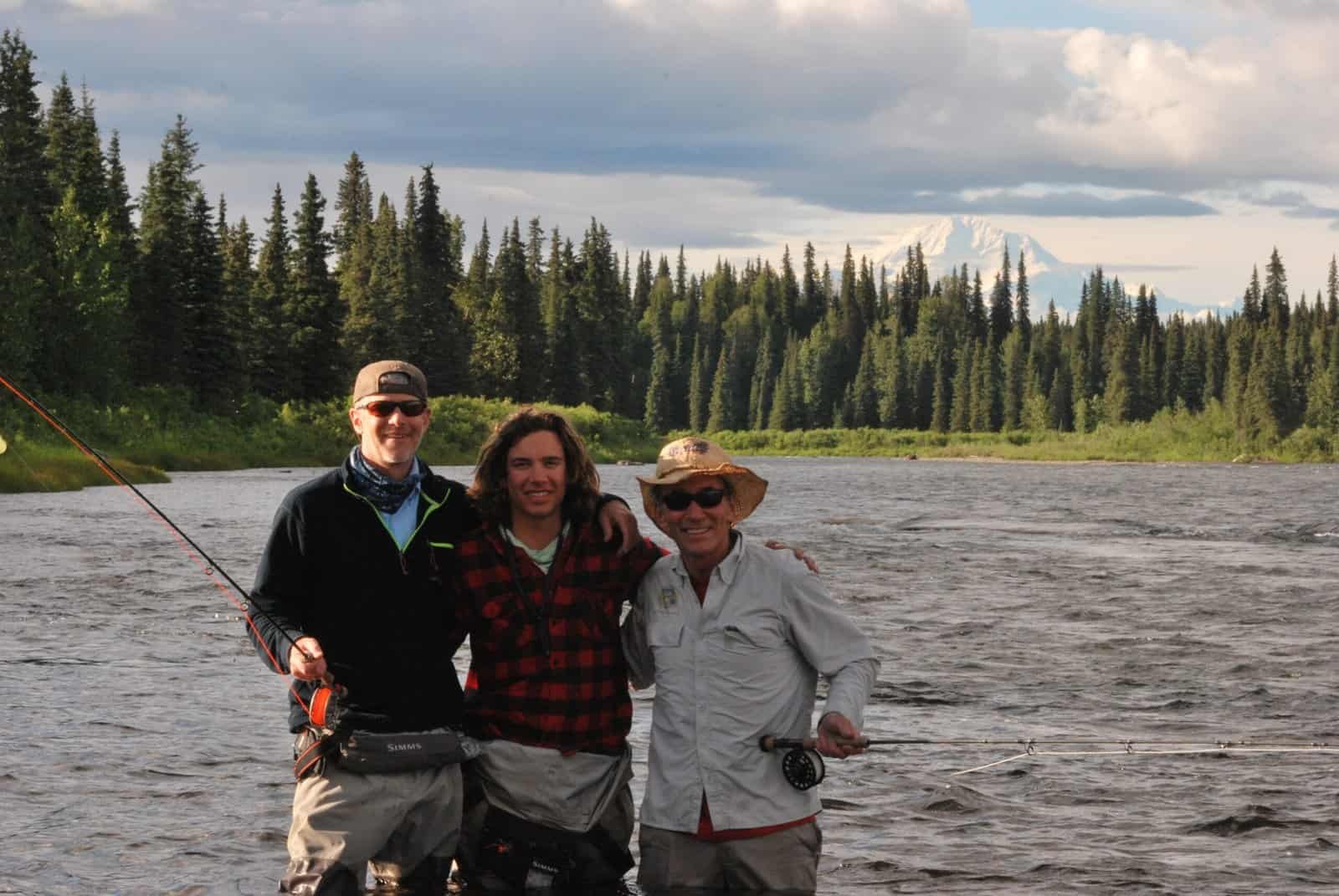 A group poses on the river with their fishing guide as they live out the perfect day's fishing itinerary.