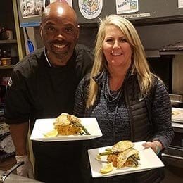 Happy servers at Wilderness Place Lodge, Alaska present guests another five star dinner entree.